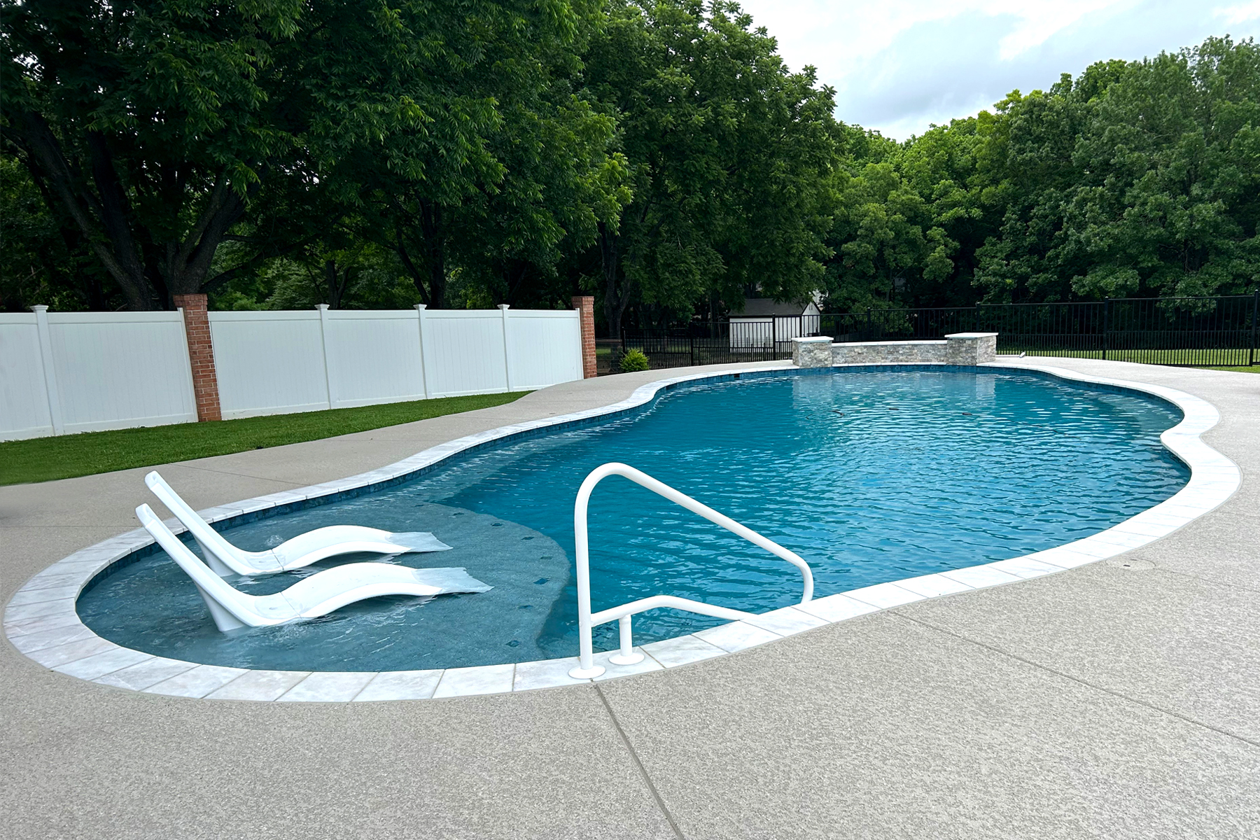 A RiverMist backyard pool glowing at dusk